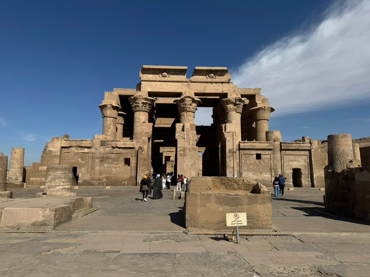 Close-up of ancient Egyptian reliefs on the wall of Kom Ombo temple, showing pharaohs and gods.