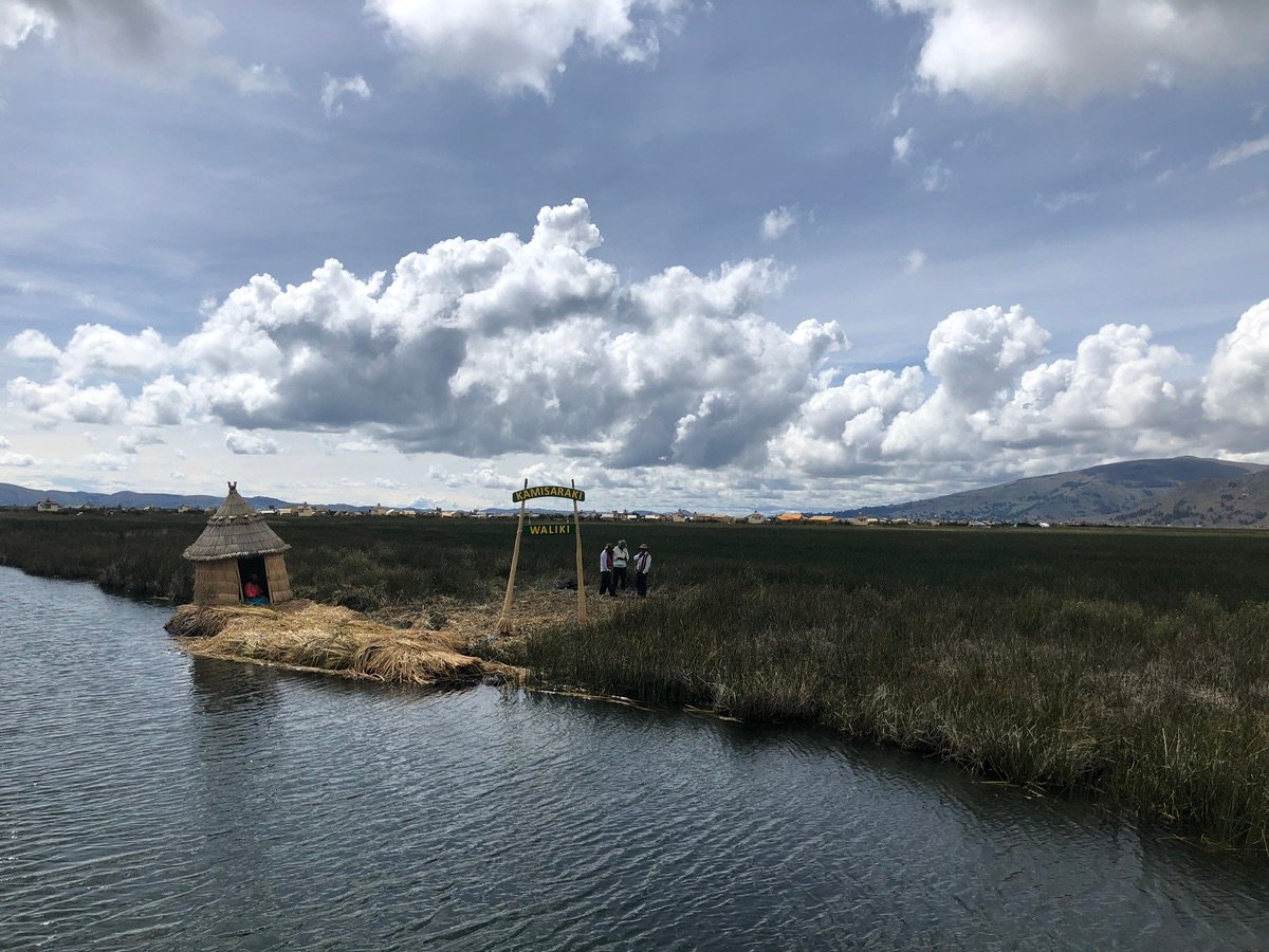 Reed hut and welcome sign on a floating Uros Island