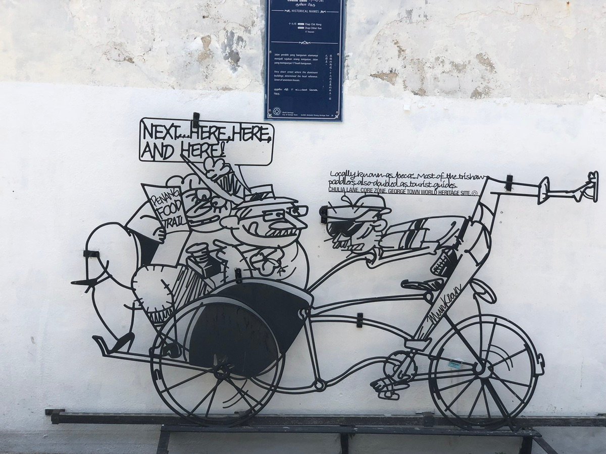 Blue historical plaque on a street in Chulia Lane