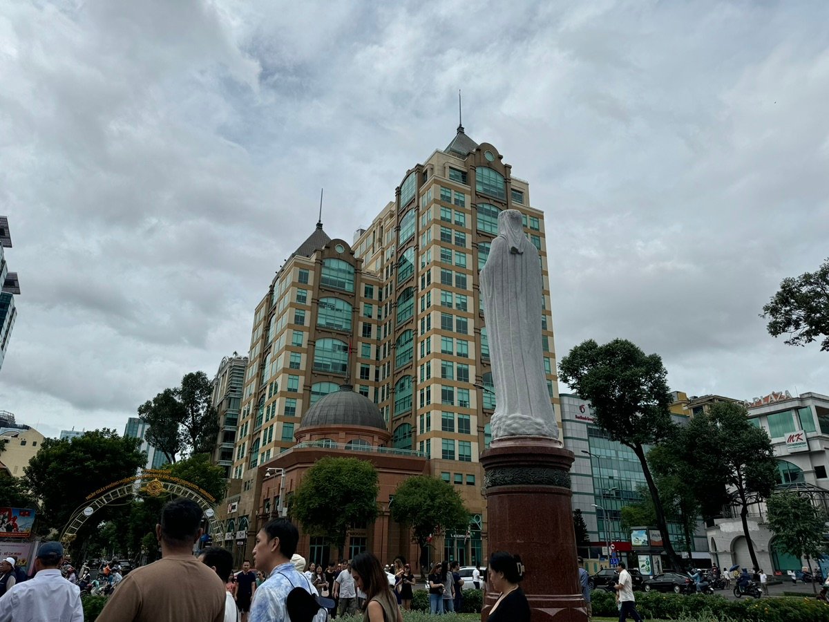The statue of the Virgin Mary in front of the scaffolding-covered Notre Dame Cathedral.
