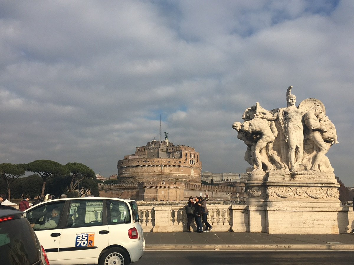 Statue on Ponte SantAngelo overlooking the Tiber River