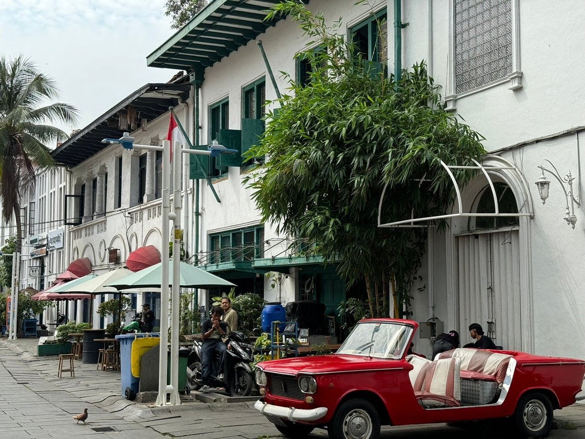 Overview of Fatahillah Square with Jakarta History Museum and bustling people
