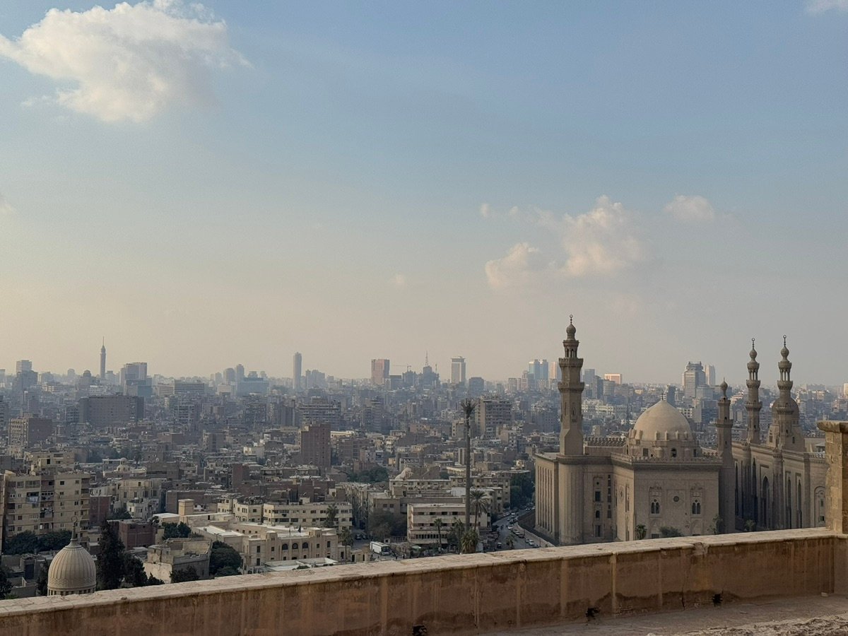 People gathered near the arched entrance of the mosque