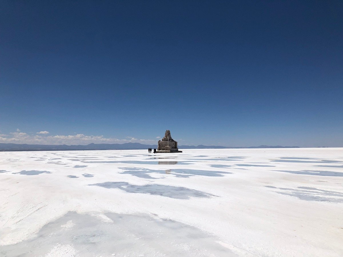 Reflective surface of the salt flats under a blue sky