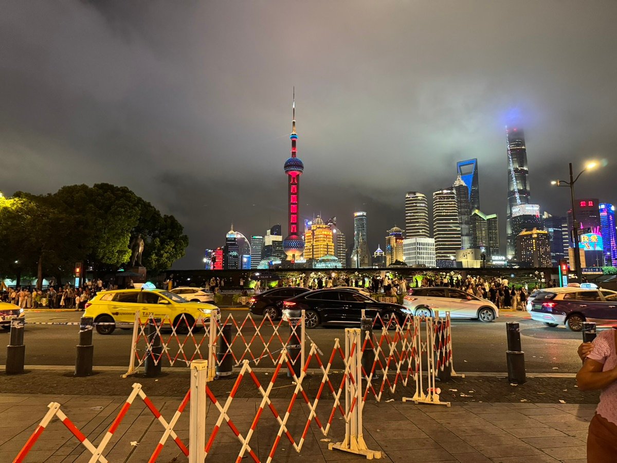 Distant view of Nanjing Road Pedestrian Street, lit with pink and orange lights
