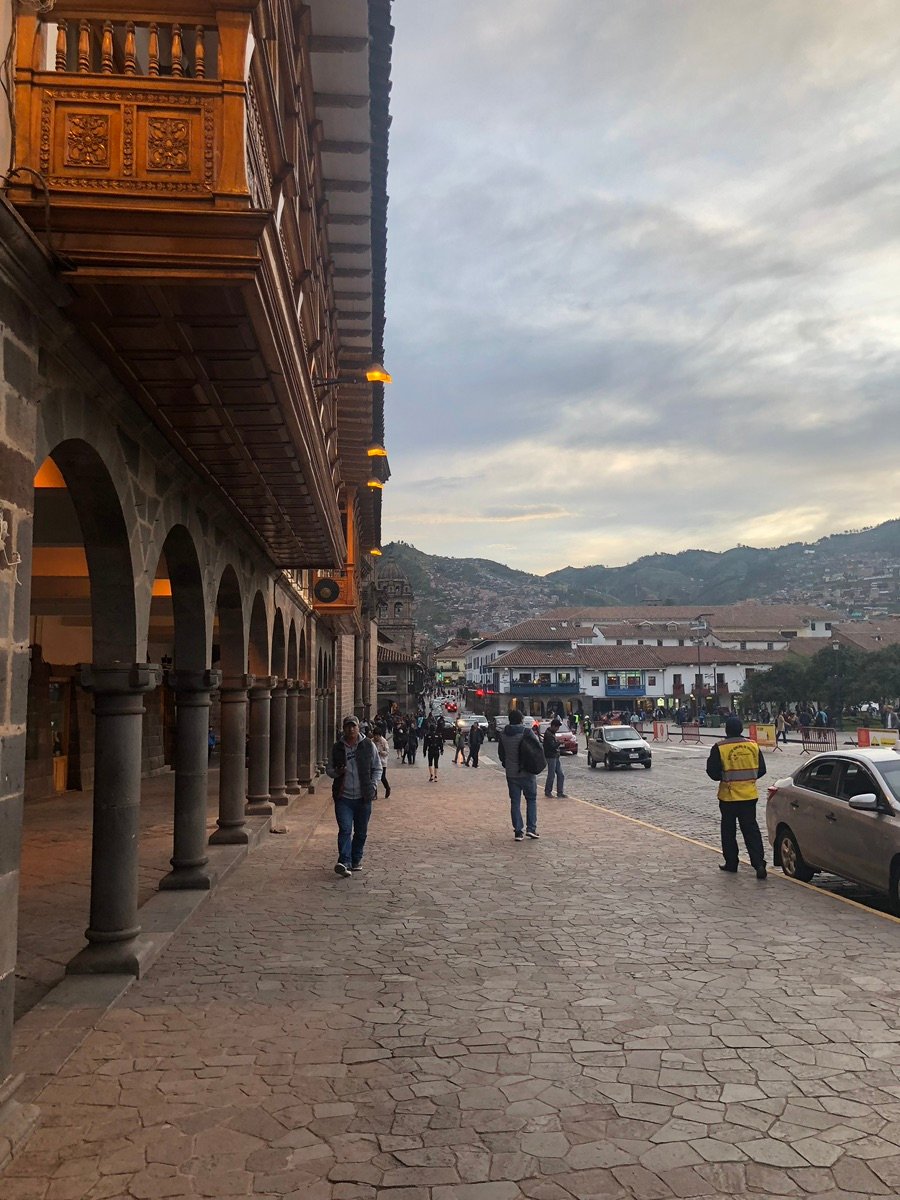 Road adjacent to Plaza de Armas with a local traffic safety sign