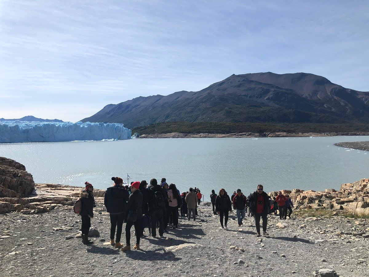 Back of people looking at the edge of the glacier