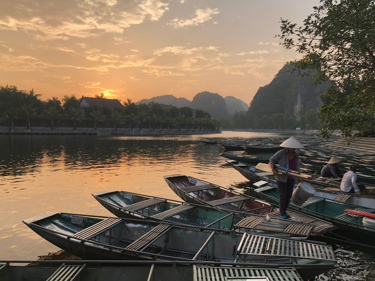 Tam Coc boats on sunset-lit water
