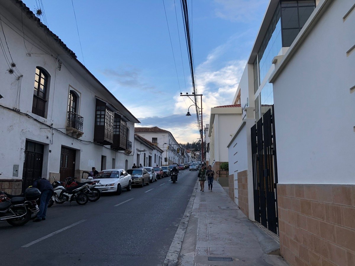 Close-up of white colonial buildings and power lines in Sucre, Bolivia
