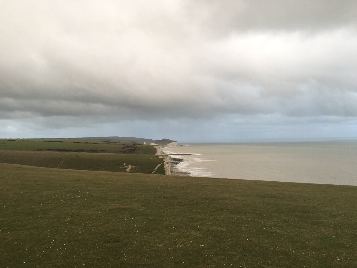 Path leading to the beach with cliffs in view