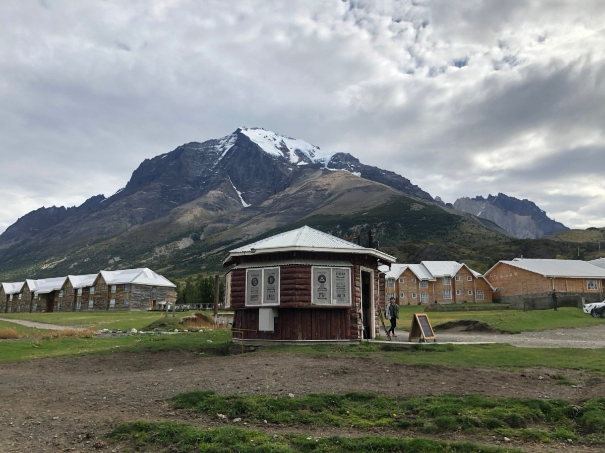 Rustic wooden lodges against the mountains
