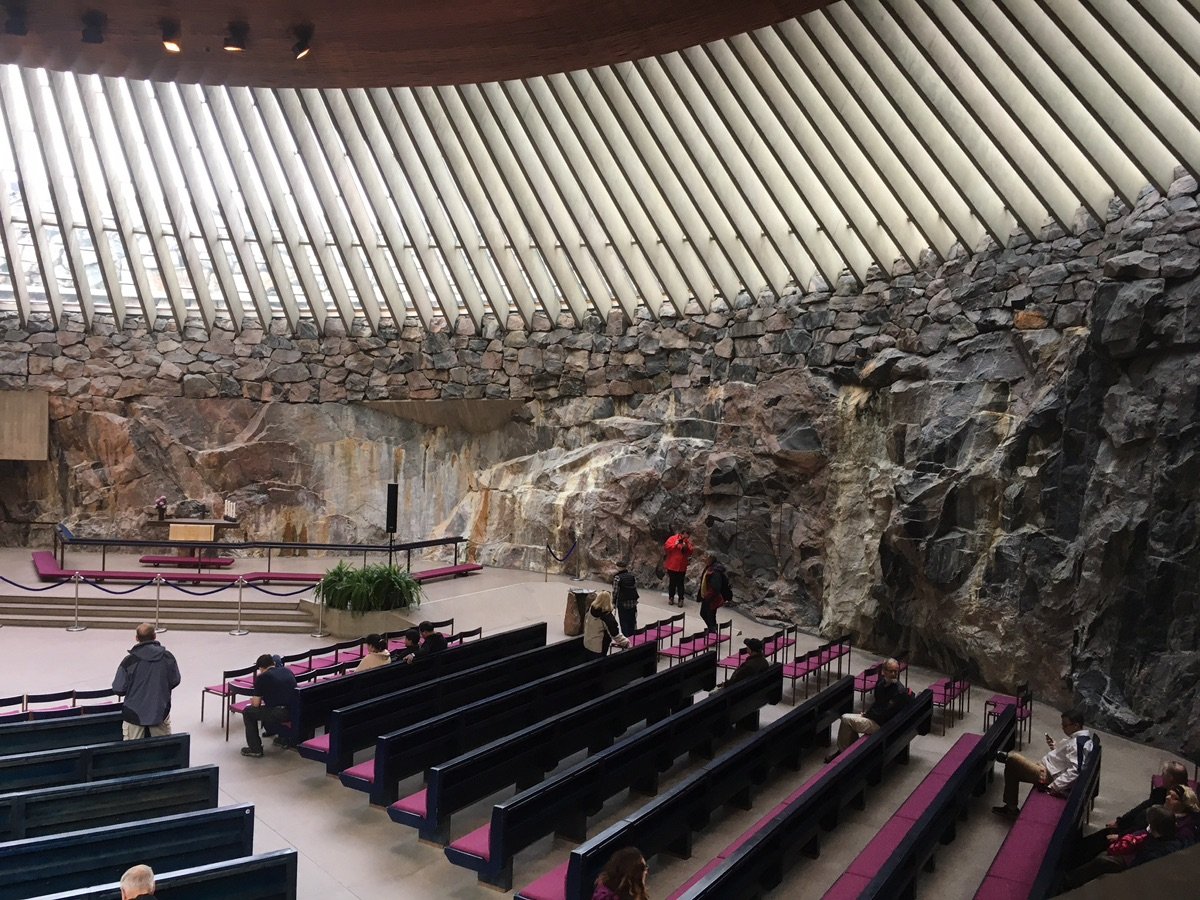 Inside Helsinki's Temppeliaukio Church, with its rugged rock walls and slatted ceiling.