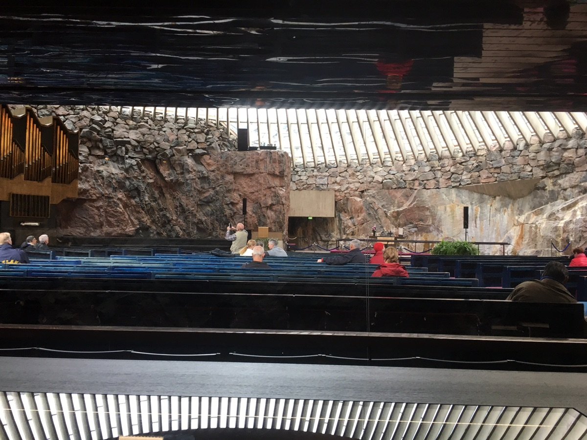 Visitors sit in the pews inside Helsinki's Temppeliaukio Church.