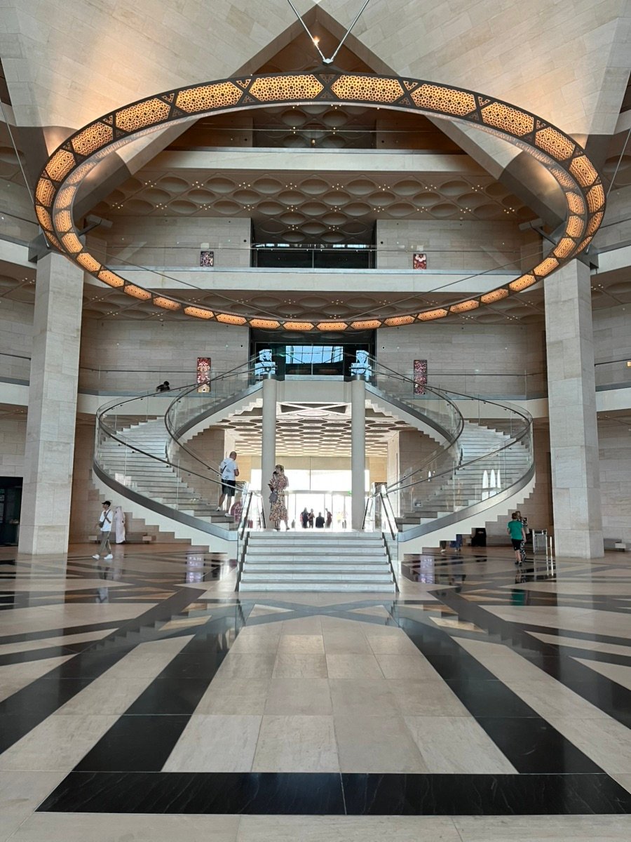 The curved staircase and giant circular light inside Doha's Museum of Islamic Art.