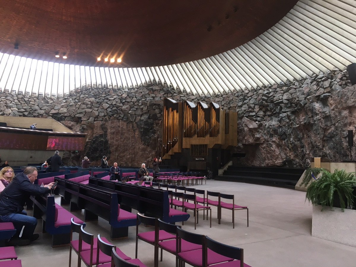 The rugged rock walls and copper dome of Temppeliaukio Church in Helsinki.
