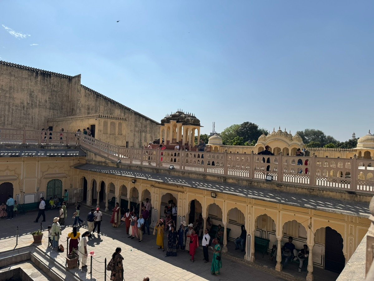 People exploring the inner courtyard of the Hawa Mahal in Jaipur.