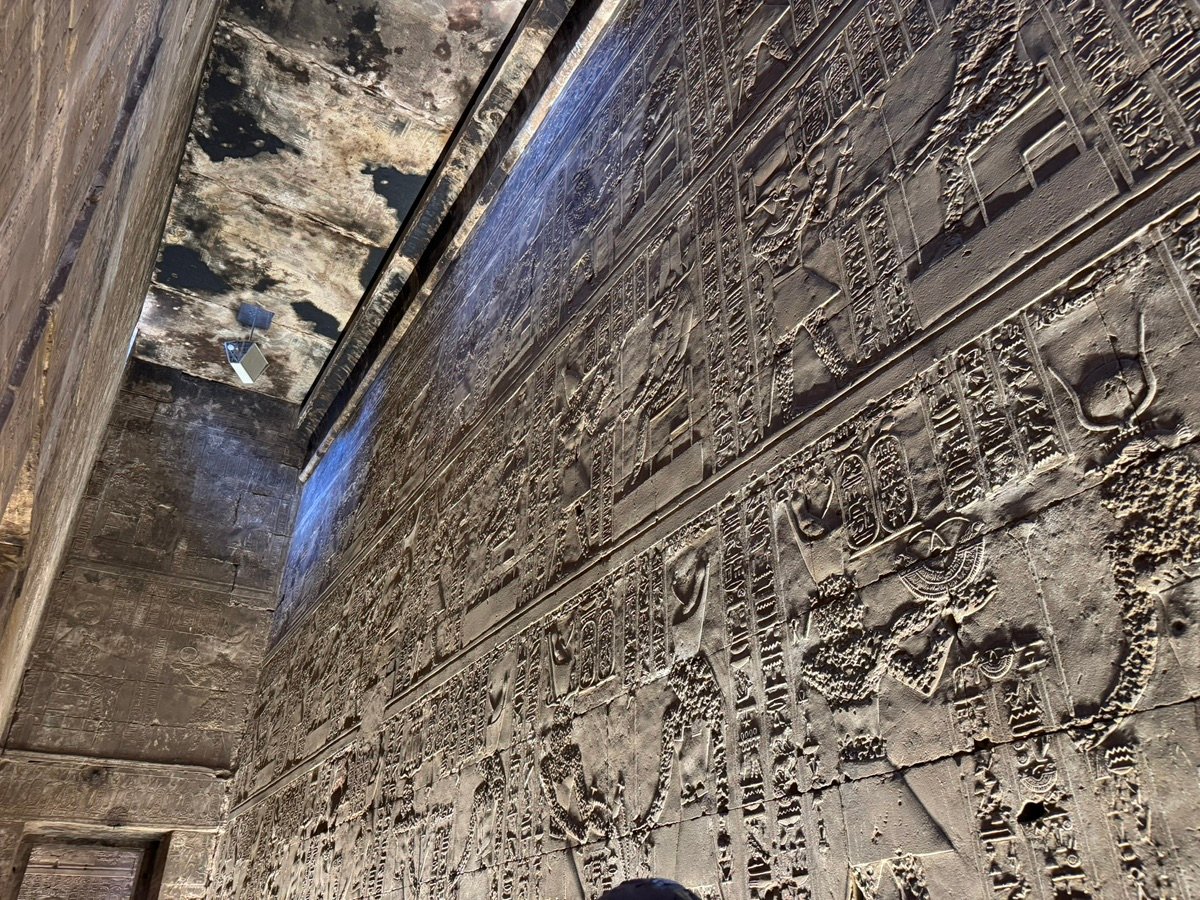 Ancient stone carvings cover the high walls of the Edfu Temple.